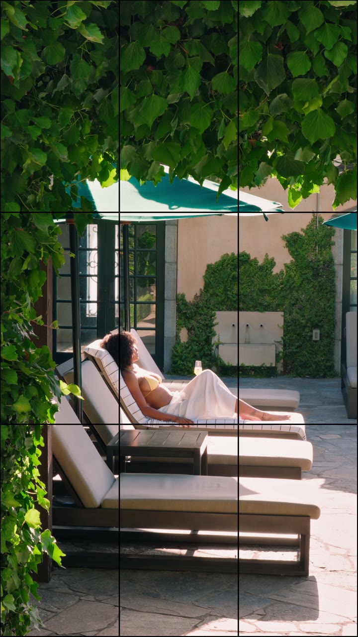 A guest relaxing on a terrace framed by green vines